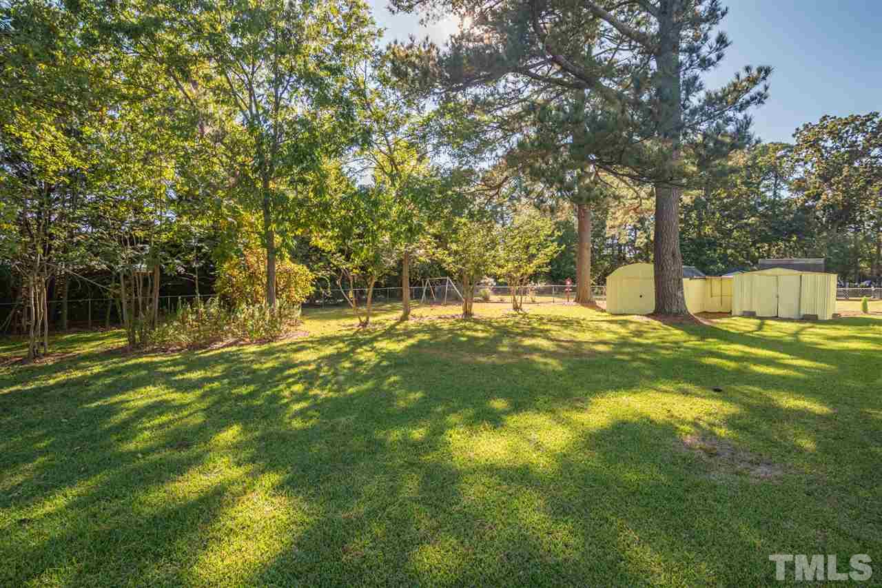 1405 Beichler Road Garner, NC 27529 - Photo 18 of 19 Back yard is large and flat with beautiful, mature shade trees.