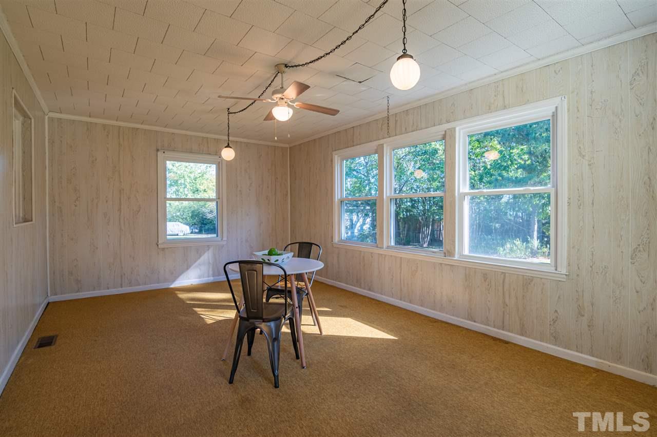 1405 Beichler Road Garner, NC 27529 - Photo 9 of 19 Sunny room overlooking the back yard with endless possibilities! Could use as a play room, sitting area, or additional dining area! Great multi-purpose room.