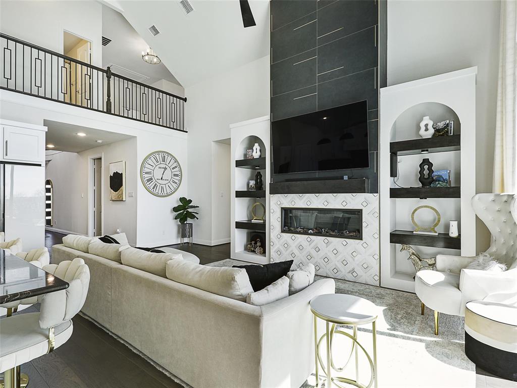 3141 Sunfish Street Prosper, TX 75078 - Photo 11 of 33 a living room with furniture a flat screen tv and a fireplace