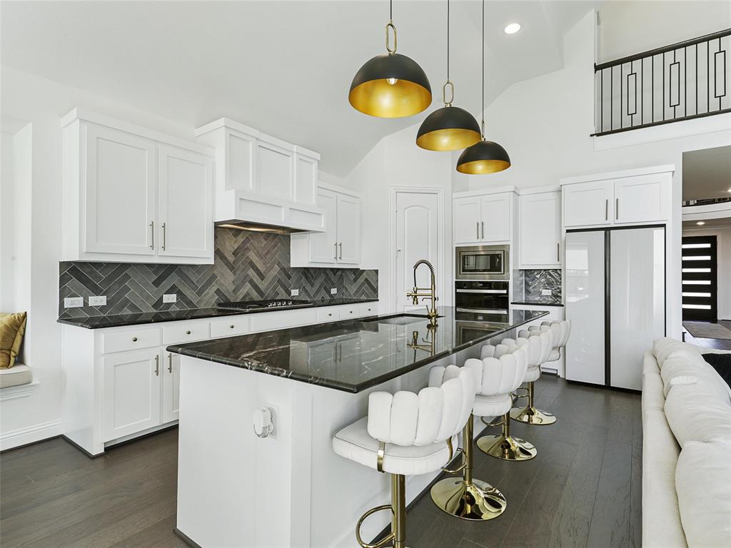 3141 Sunfish Street Prosper, TX 75078 - Photo 12 of 33 a kitchen with stainless steel appliances granite countertop a sink a stove counter space and cabinets