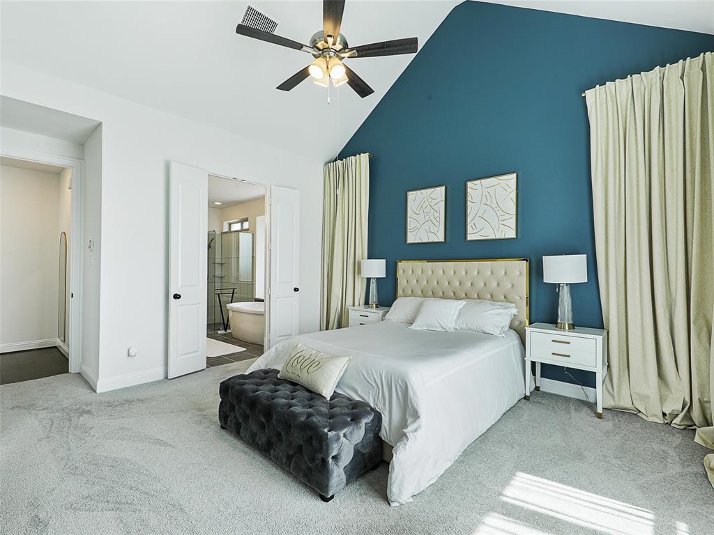 3141 Sunfish Street Prosper, TX 75078 - Photo 17 of 33 a spacious bedroom with a bed and a chandelier