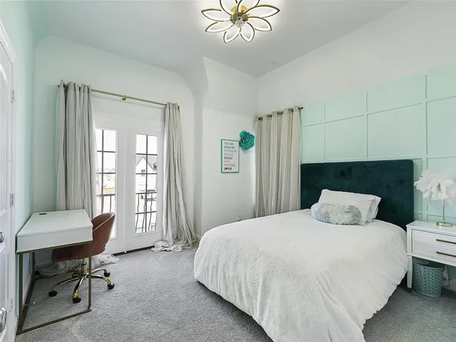 a bedroom with a bed and a table in it