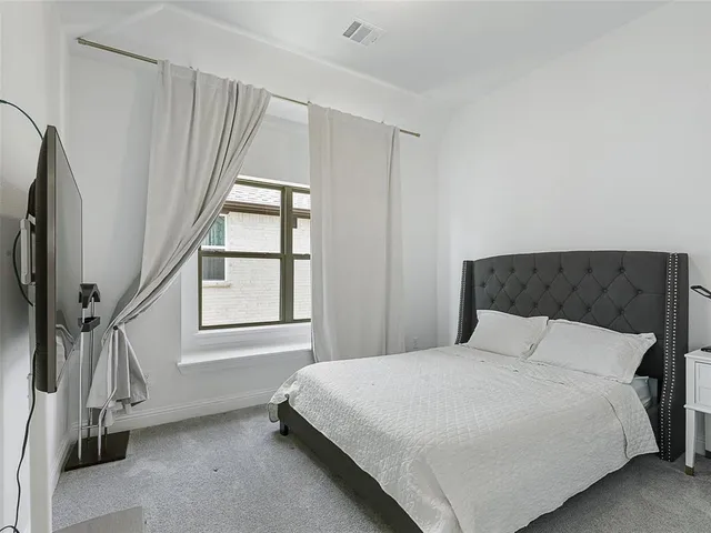 a bedroom with a bed and a table in it