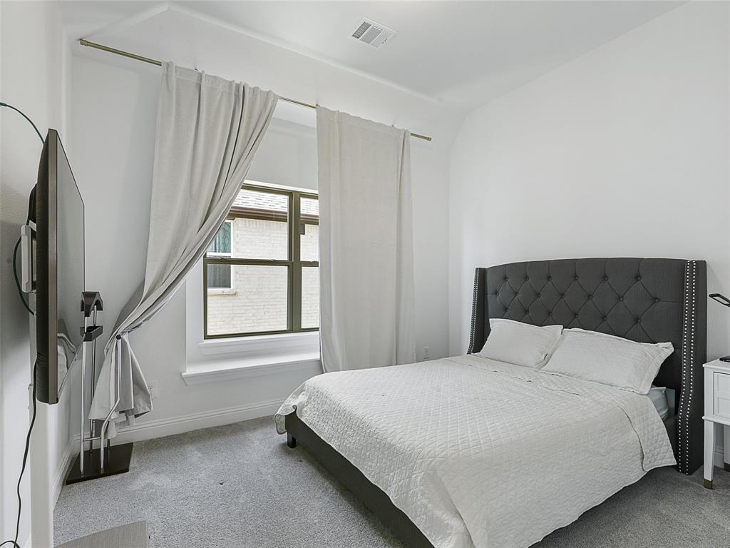 3141 Sunfish Street Prosper, TX 75078 - Photo 23 of 33 a bedroom with a bed next to a window