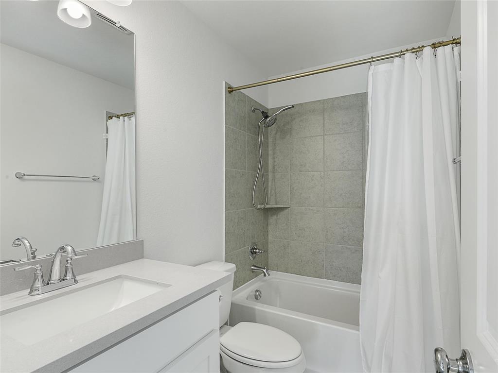 3141 Sunfish Street Prosper, TX 75078 - Photo 24 of 33 a bathroom with a granite countertop sink toilet and shower