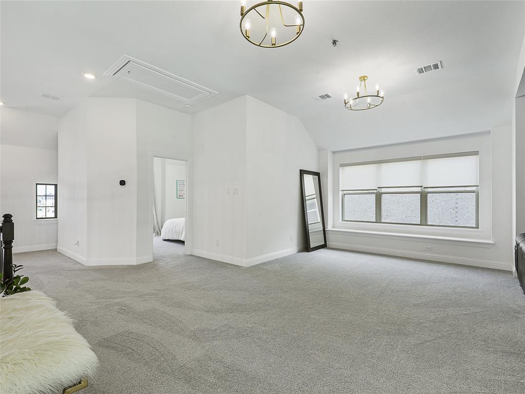 3141 Sunfish Street Prosper, TX 75078 - Photo 25 of 33 an empty room with chandelier fan and windows