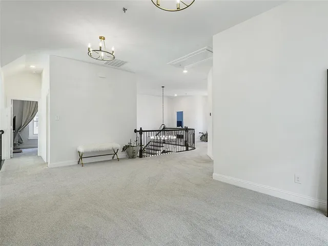 a living room with couches and chandelier