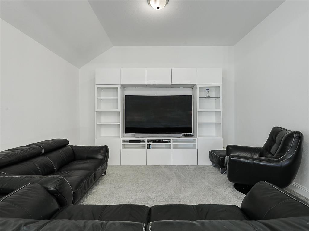 3141 Sunfish Street Prosper, TX 75078 - Photo 28 of 33 a living room with furniture and a flat screen tv