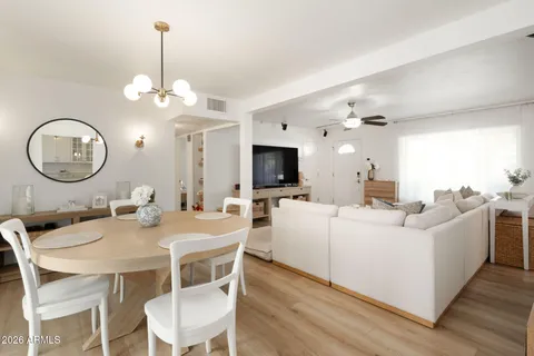a view of a dining room with furniture and a chandelier