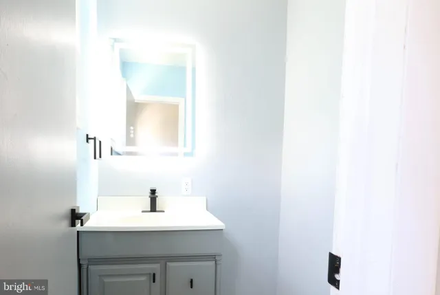 a bathroom with a sink and a mirror