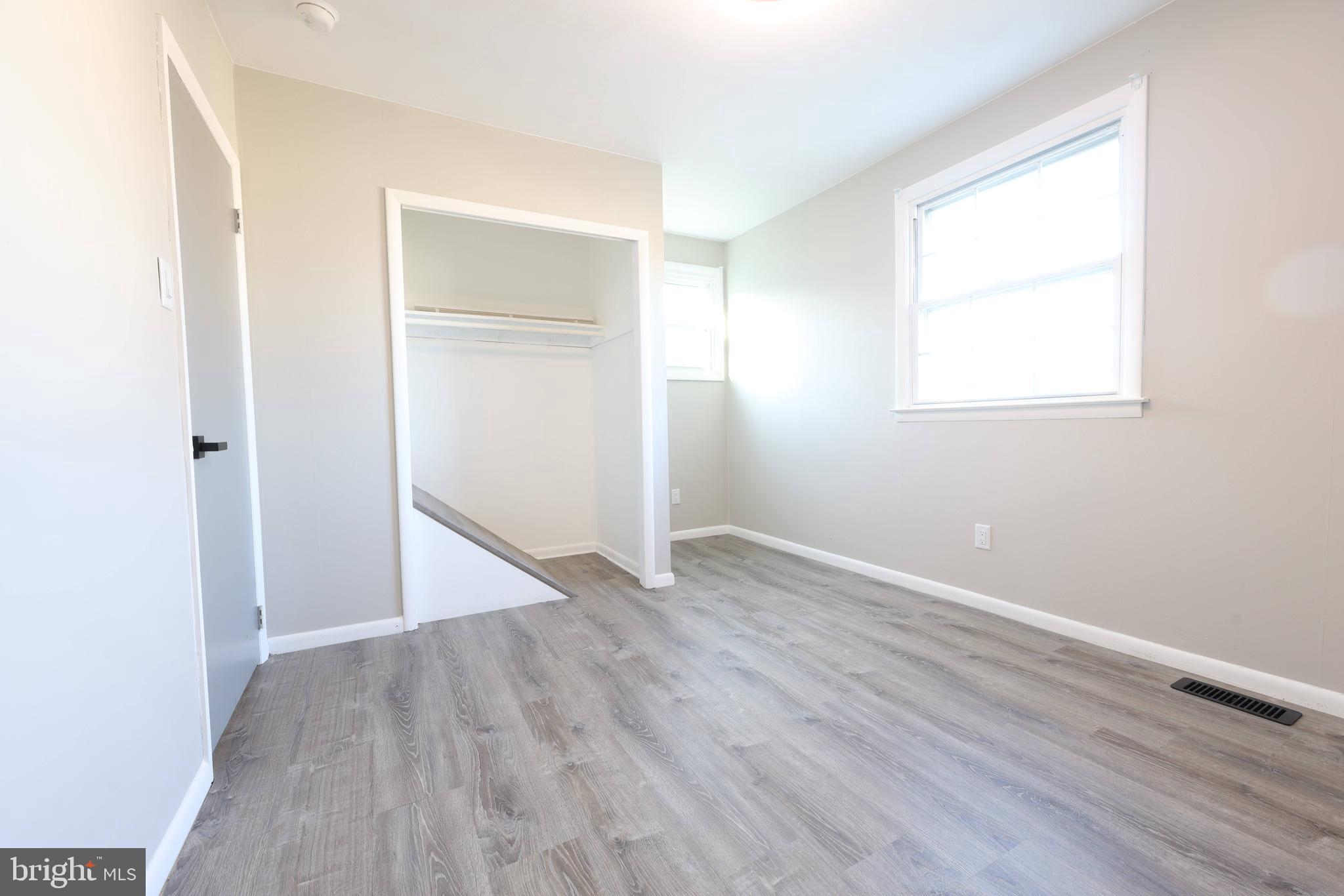 22 Clemson Road Cherry Hill, NJ 08034 - Photo 17 of 25 an empty room with wooden floor closet and windows