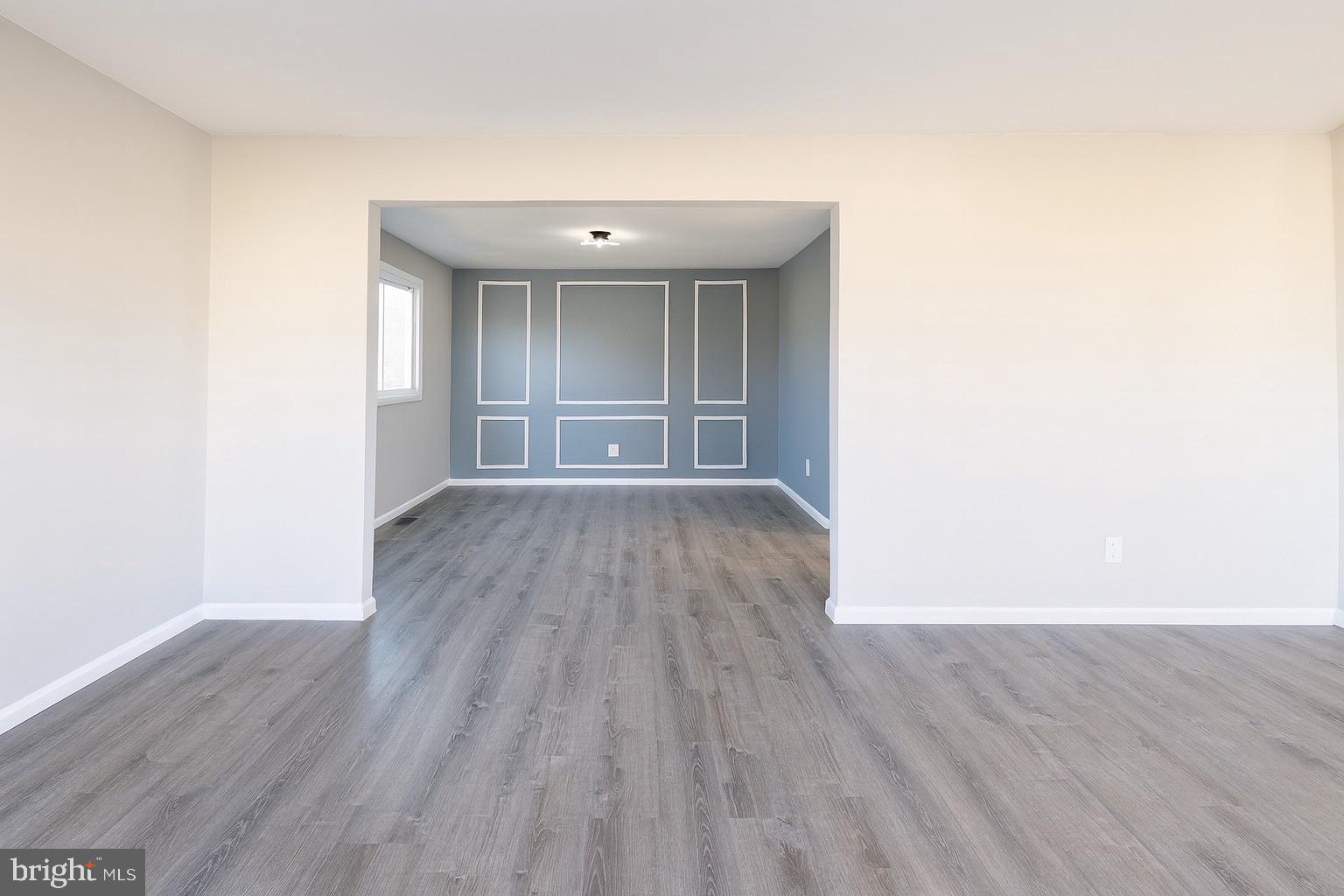 22 Clemson Road Cherry Hill, NJ 08034 - Photo 6 of 25 an empty room with wooden floor and windows