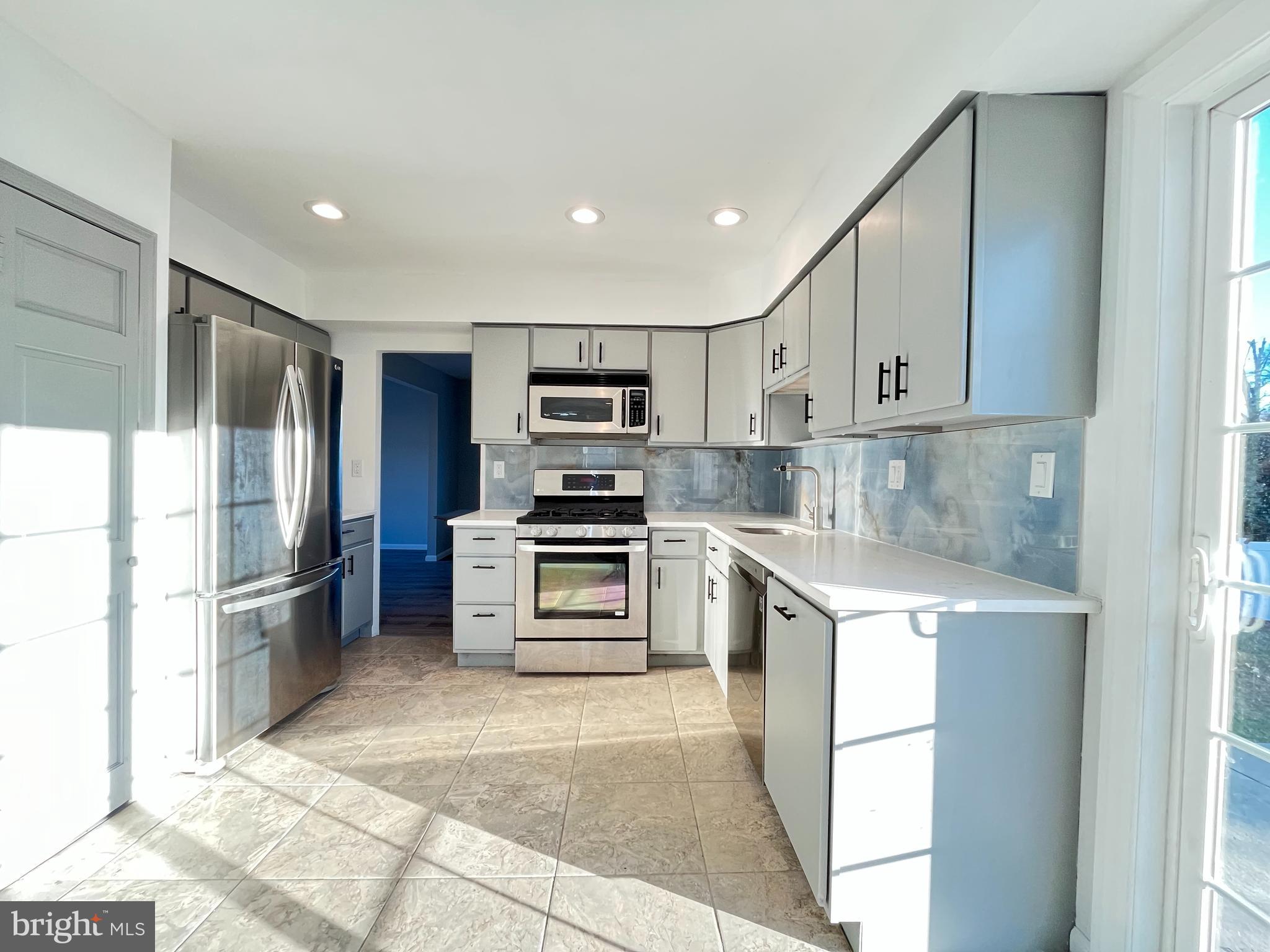 22 Clemson Road Cherry Hill, NJ 08034 - Photo 7 of 25 a kitchen with kitchen island a sink stove and refrigerator