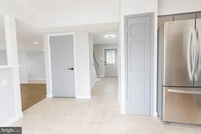 a view of a kitchen with a refrigerator and a sink
