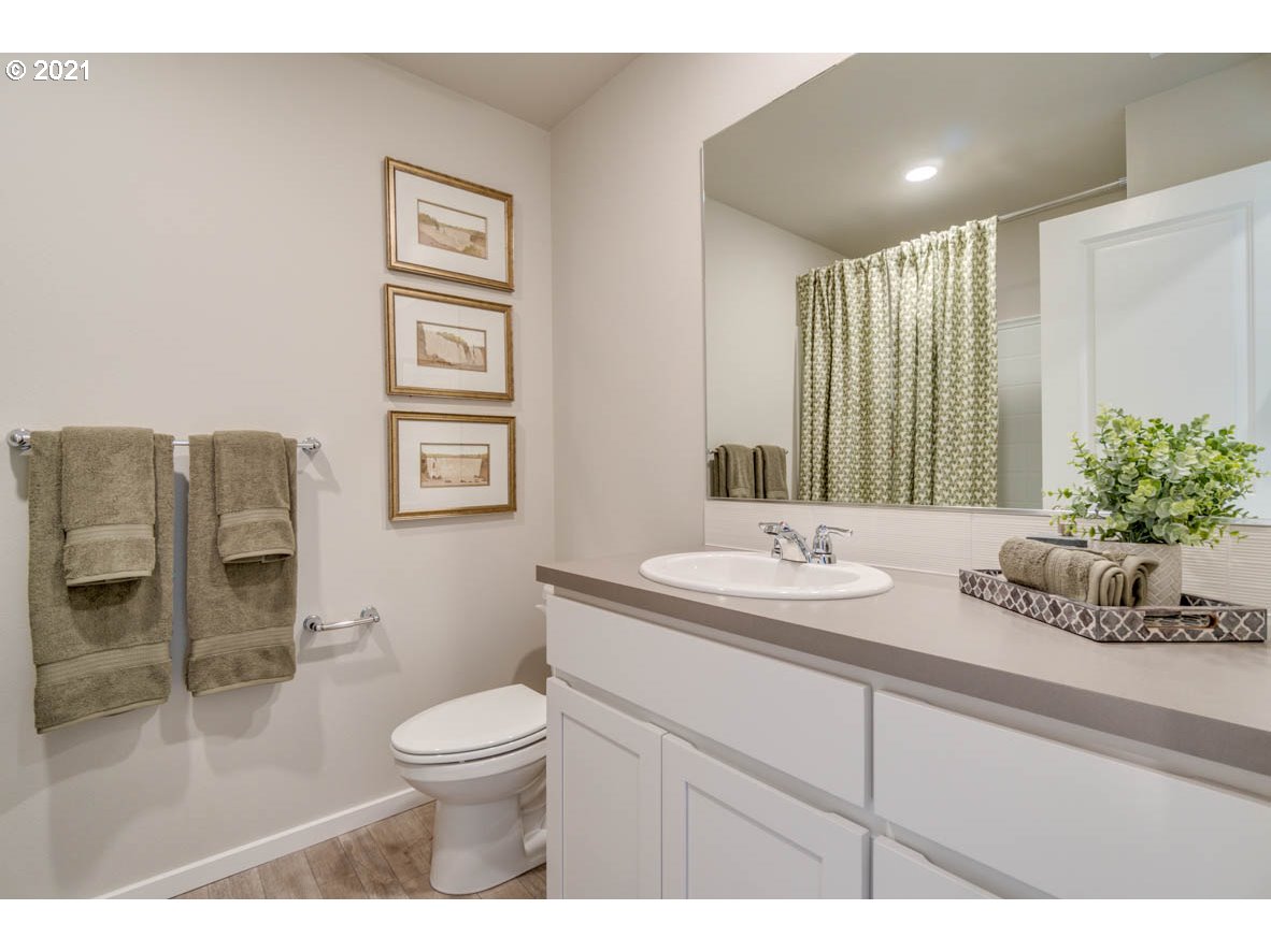 15784 Northwest Brugger Road Portland, OR 97229 - Photo 13 of 21 a bathroom with a toilet a sink and mirror