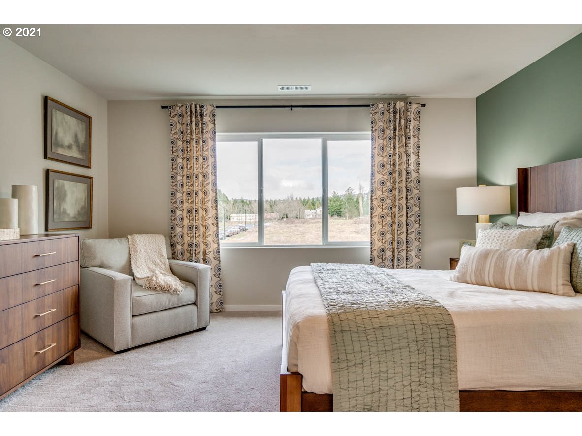15784 Northwest Brugger Road Portland, OR 97229 - Photo 15 of 21 a bedroom with a bed and a large window