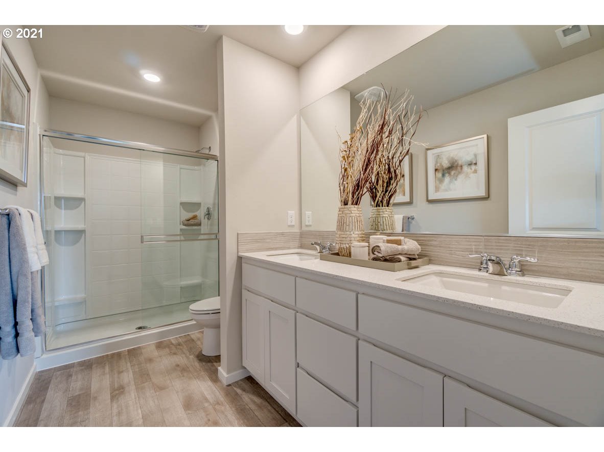 15784 Northwest Brugger Road Portland, OR 97229 - Photo 17 of 21 a bathroom with a double vanity sink mirror and shower