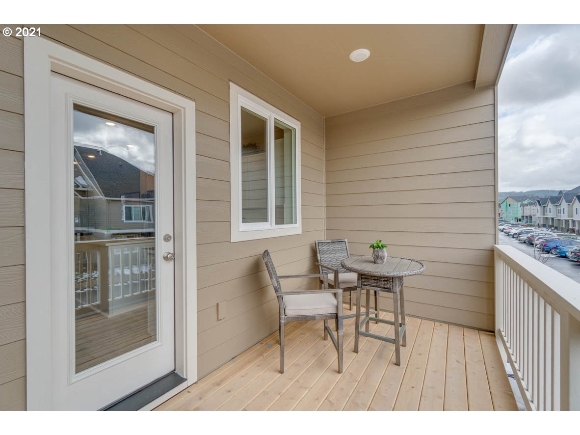 15784 Northwest Brugger Road Portland, OR 97229 - Photo 21 of 21 a balcony with table and chairs
