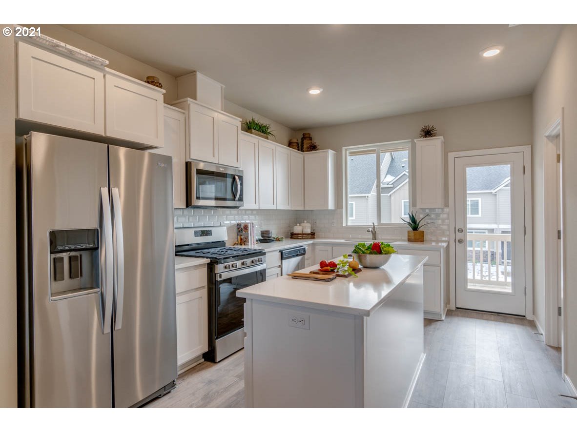 15784 Northwest Brugger Road Portland, OR 97229 - Photo 6 of 21 a kitchen with stainless steel appliances a refrigerator stove microwave and sink