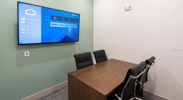 a view of a dining room with a table and chairs