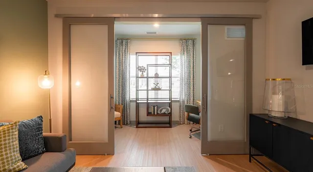 a bedroom with a bed and a night stand