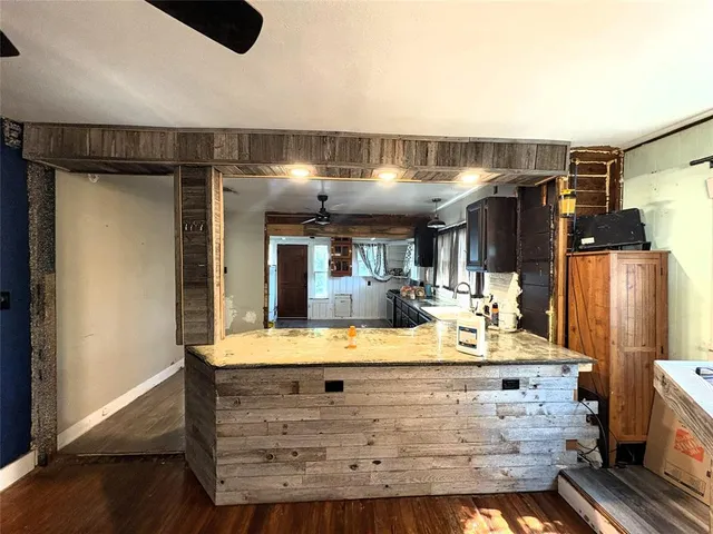 a living room with hard wood floors and a fireplace