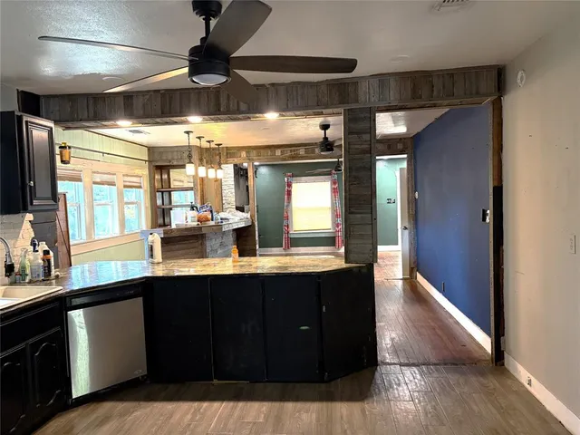 a view of kitchen with refrigerator and wooden floor