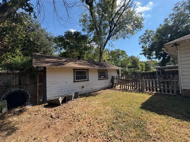 a view of backyard and a tree