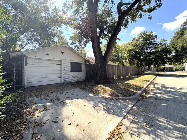 a view of a white house with a yard