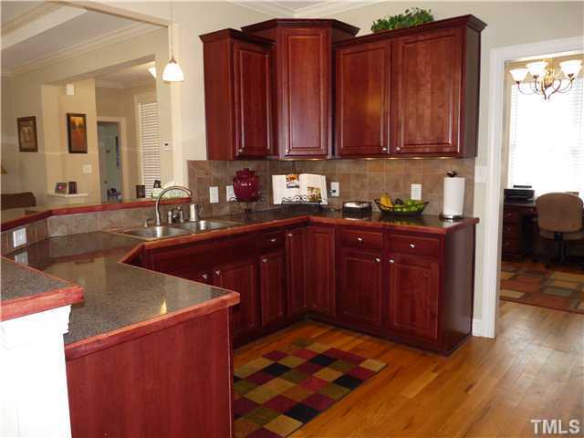 220 Weaver Ridge Road Rougemont, NC 27572 - Photo 4 of 12 a kitchen with stainless steel appliances granite countertop a sink dishwasher stove and wooden cabinets