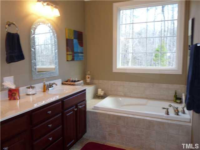 220 Weaver Ridge Road Rougemont, NC 27572 - Photo 9 of 12 a bathroom with a tub sink and mirror