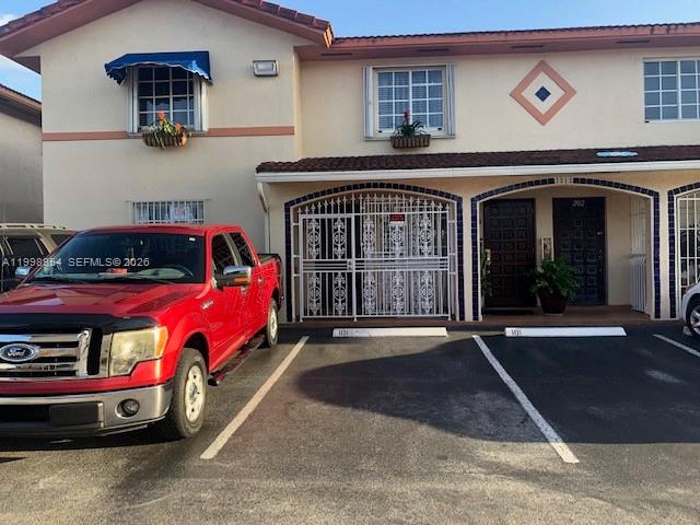 2212 West 74th Street, Unit 10128 Hialeah, FL 33016 - Photo 1 of 12 a front view of a house with parking space