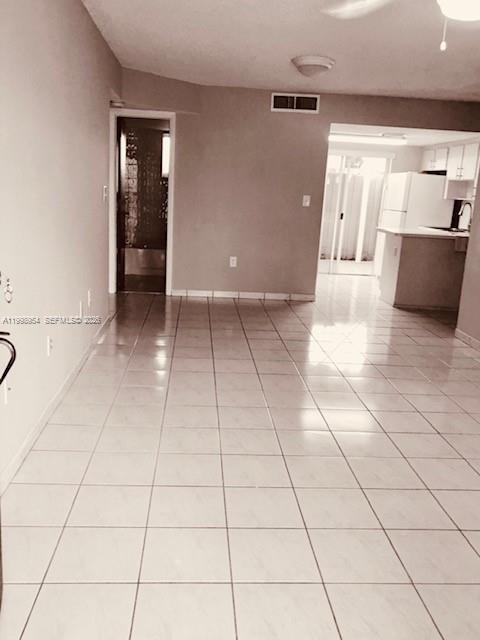 2212 West 74th Street, Unit 10128 Hialeah, FL 33016 - Photo 2 of 12 a view of a livingroom with an empty space and a refrigerator