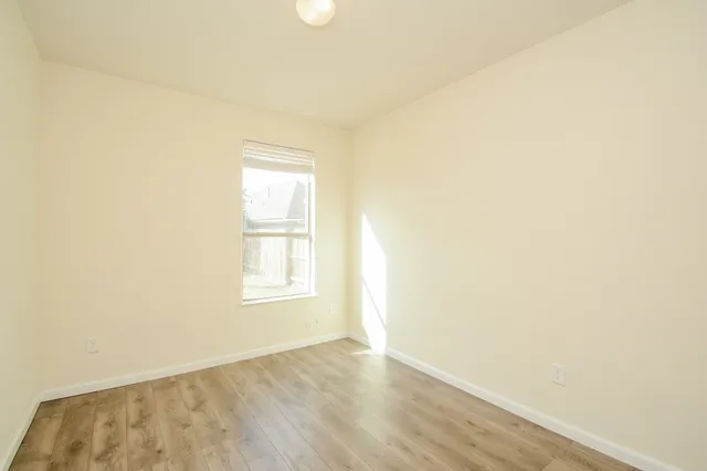 a view of kitchen island with granite countertop refrigerator sink dining table and chairs