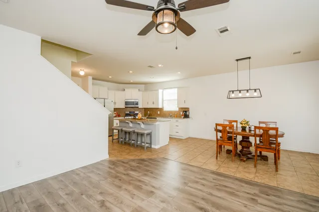 a view of a dining room with furniture and chandelier