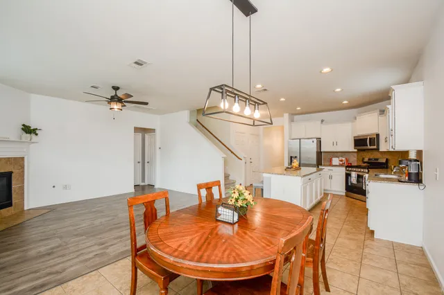 a view of an empty room with a window and a fireplace