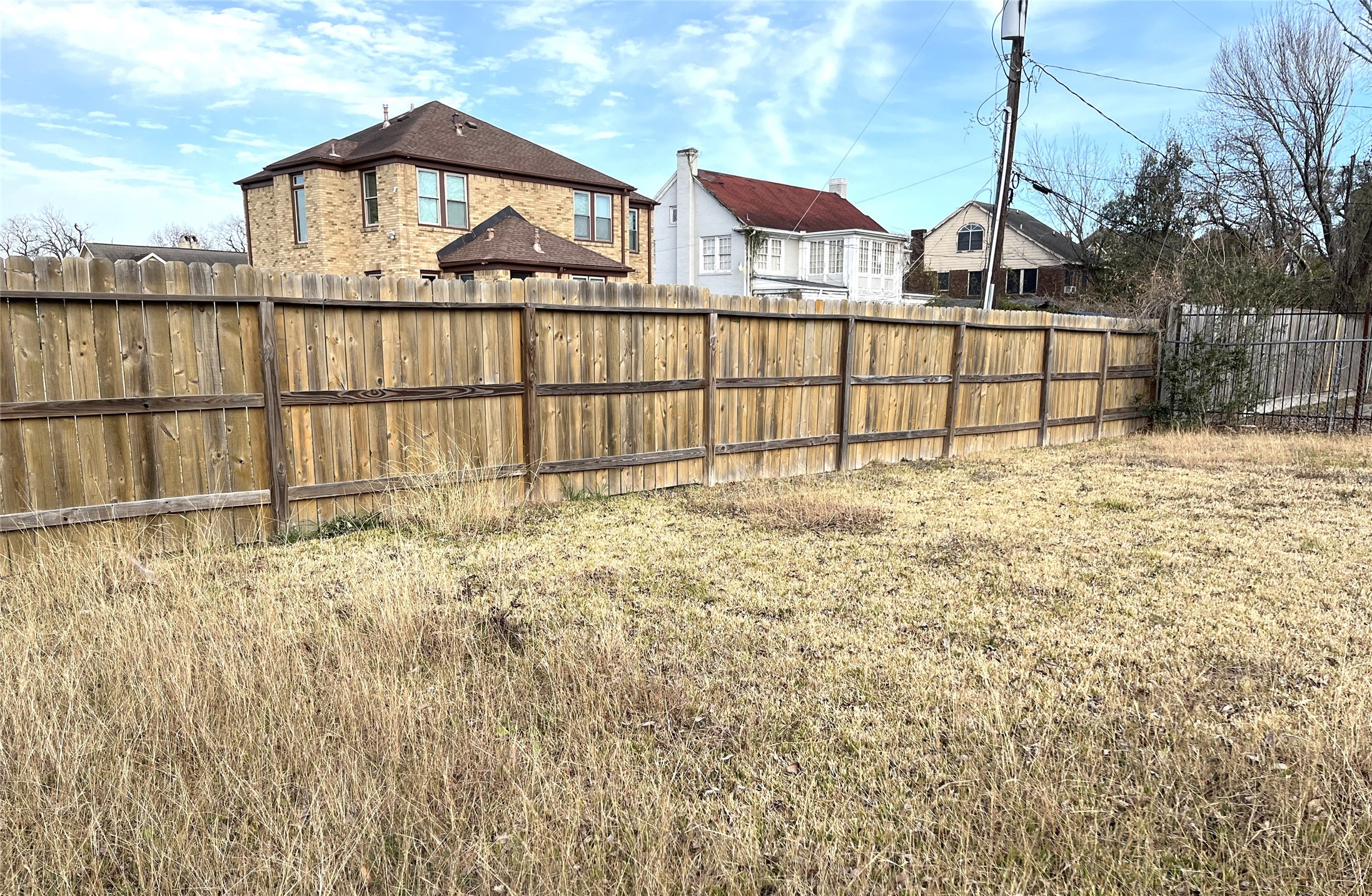 2209 Wichita Street Houston, TX 77004 - Photo 6 of 11 a view of a wooden fence and a big yard