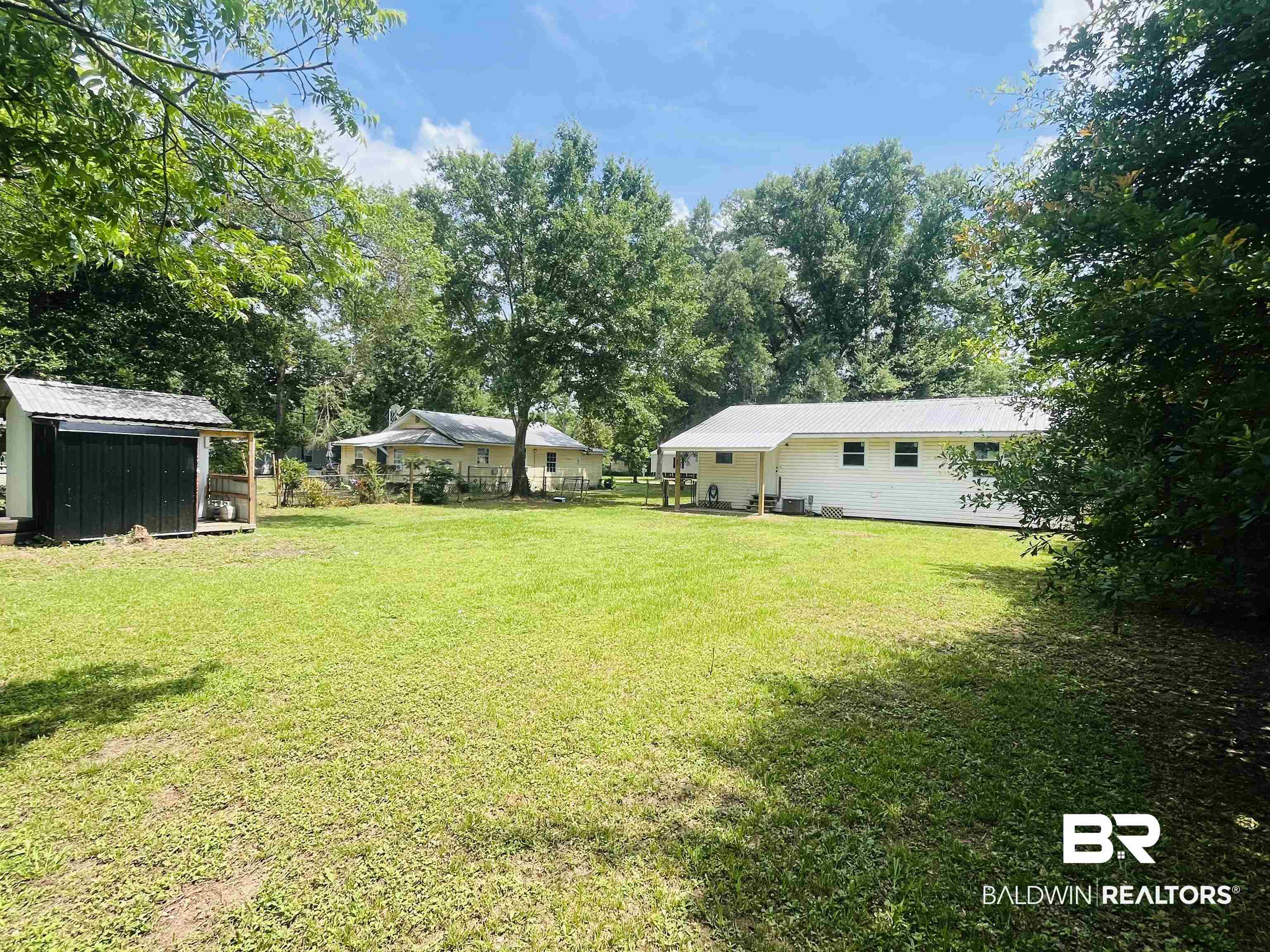 18855 Crocker Lane Foley, AL 36535 - Photo 25 of 25 View of yard with a storage unit and an outbuilding