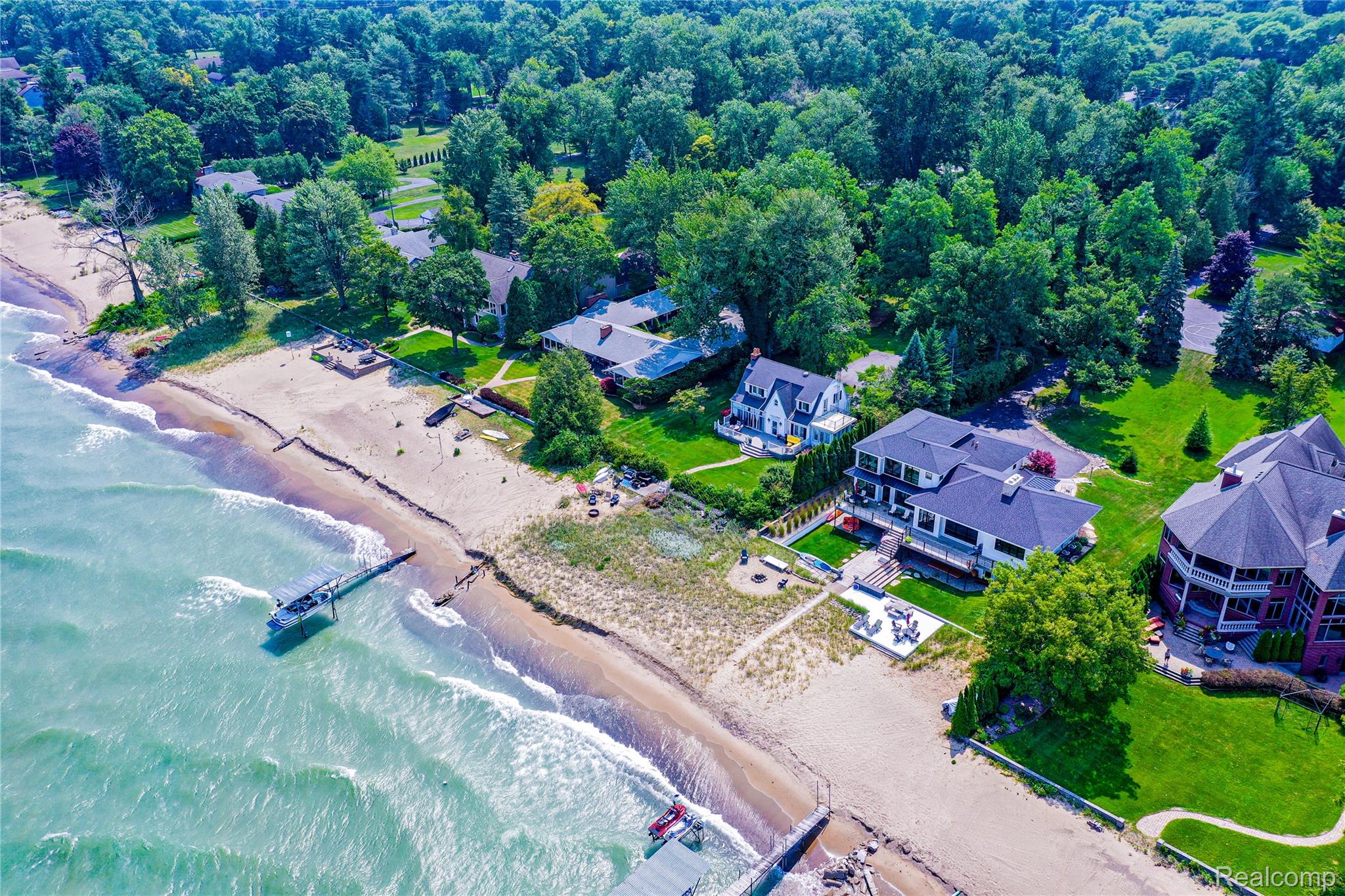 5630 Lakeshore Road Fort Gratiot, MI 48059 - Photo 43 of 49 Waterfront property featuring a private sandy beach, multiple outdoor entertaining spaces, mature landscaping, and private water access