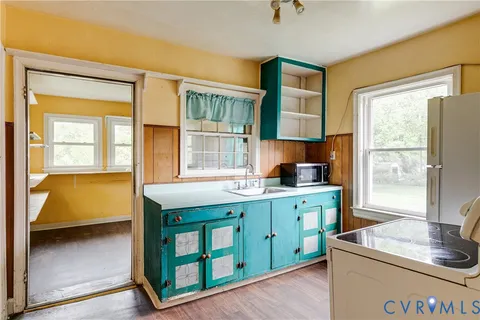 a kitchen with a stove a sink and a refrigerator
