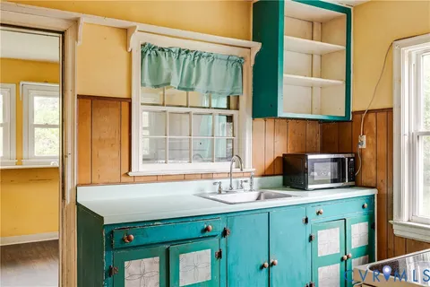 a kitchen with a sink a counter top space and a window
