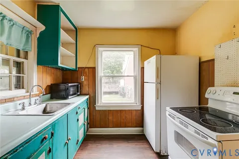 a kitchen with a sink stove and refrigerator