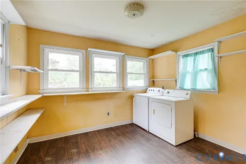 a view of storage and utility room with window washer and dryer