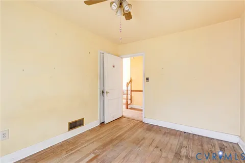 a view of a room with wooden floor