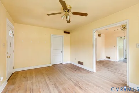 a view of an empty room and wooden floor
