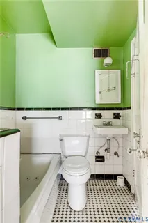 a bathroom with a sink a toilet and a mirror