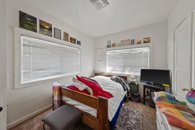 a bedroom with a bed and a window