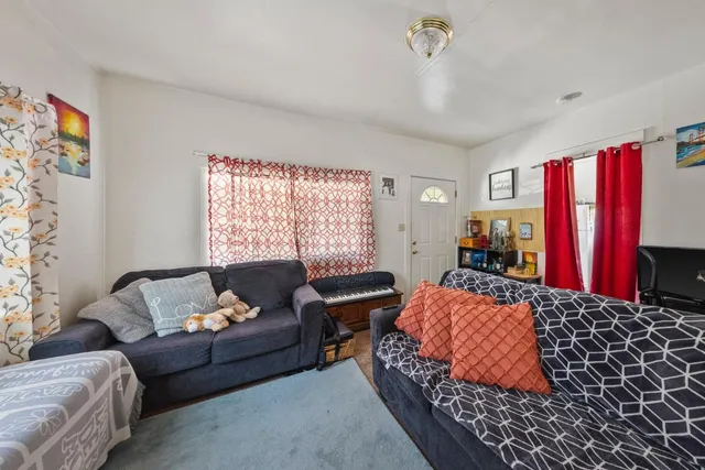 a bedroom with a bed couch and a window