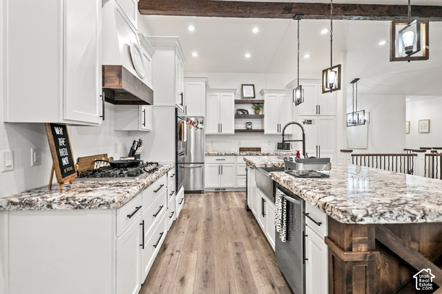 244 East Sevier River Road Central Valley, UT 84754 - Photo 25 of 66 Spacious kitchen featuring white cabinetry, wood-finish flooring, a kitchen island with a farmhouse sink, stainless steel appliances, and pendant lighting