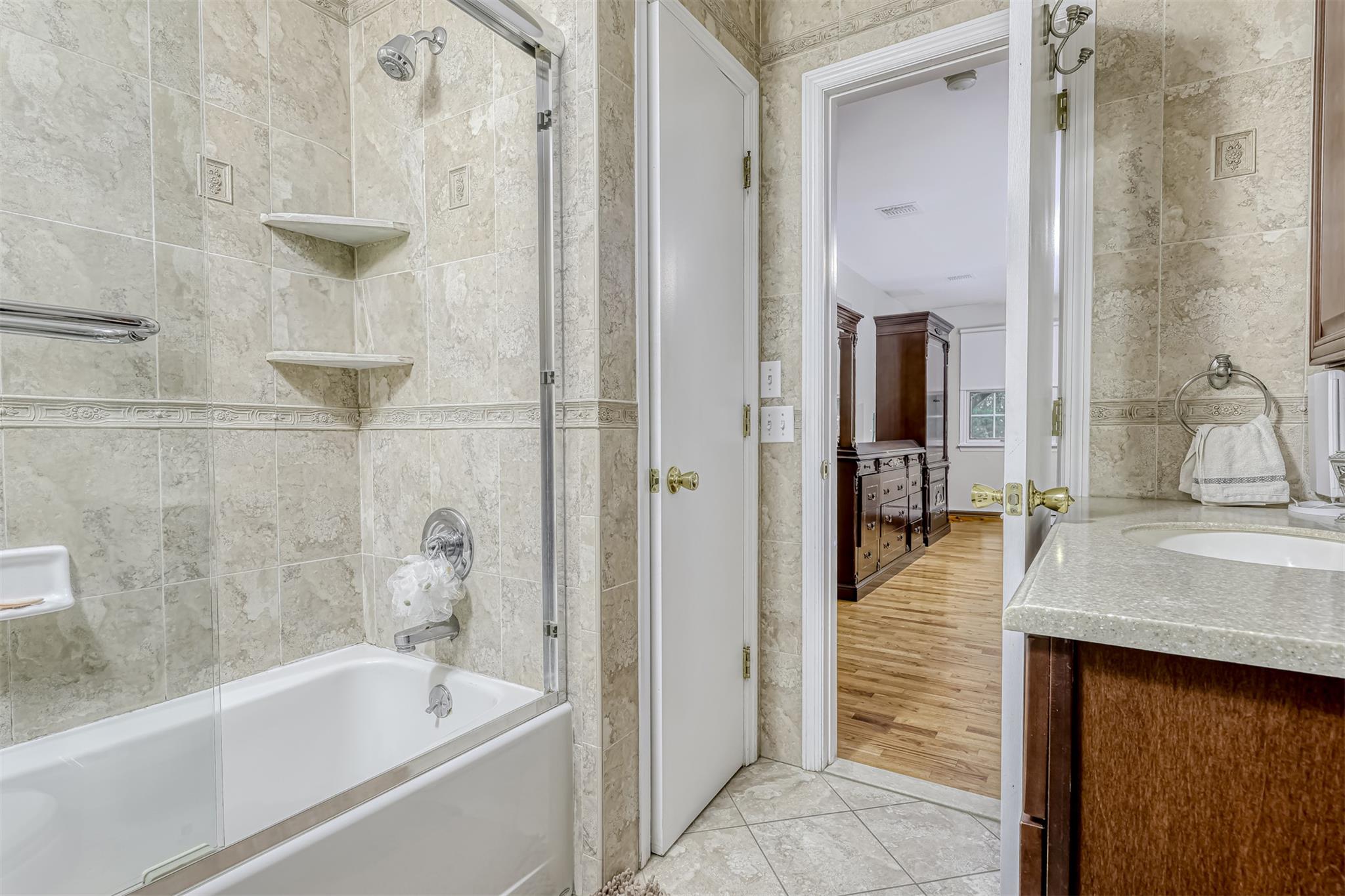 60 Highview Road Monsey, NY 10952 - Photo 15 of 26 a bathroom with a granite countertop sink a bathtub and shower